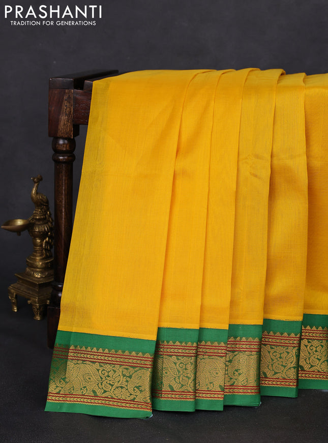 Silk cotton saree yellow and green with plain body and elephant zari woven korvai border