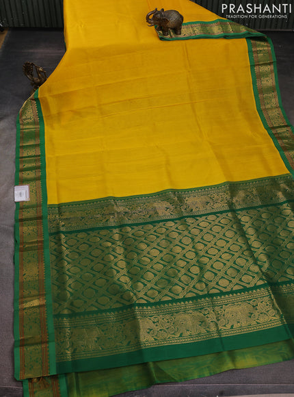 Silk cotton saree yellow and green with plain body and elephant zari woven korvai border