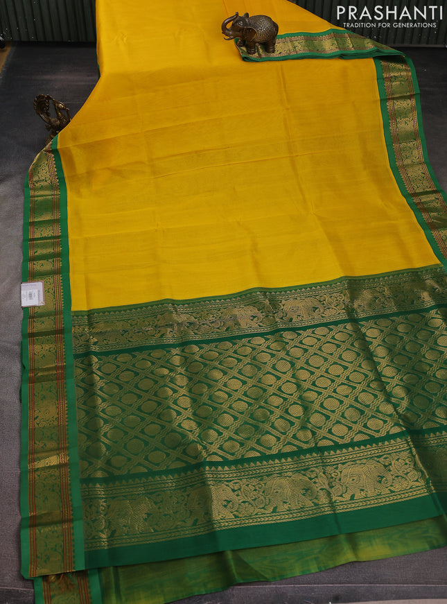 Silk cotton saree yellow and green with plain body and elephant zari woven korvai border