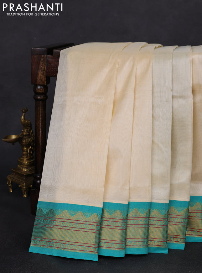 Silk cotton saree cream and teal blue with plain body and zari woven korvai border