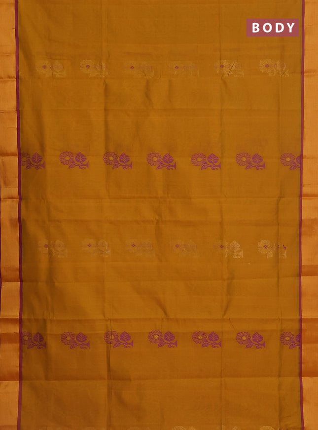 Semi silk cotton saree dark mustard and purple and floral zari woven buttas and zari woven border