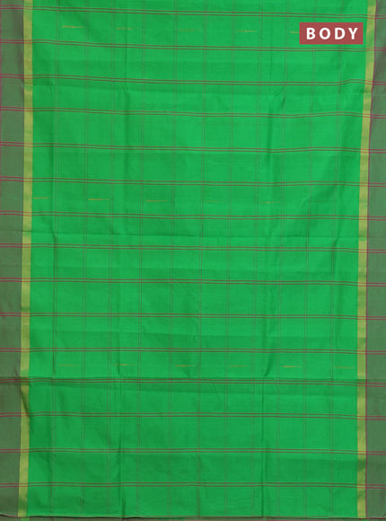 Semi silk cotton saree parrot green and pink with allover checks & buttas and zari woven simple border