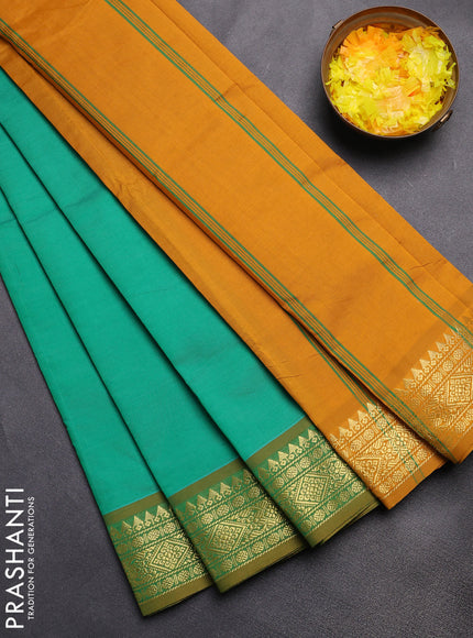 Semi silk cotton saree green and dark mustard with plain body and zari woven border