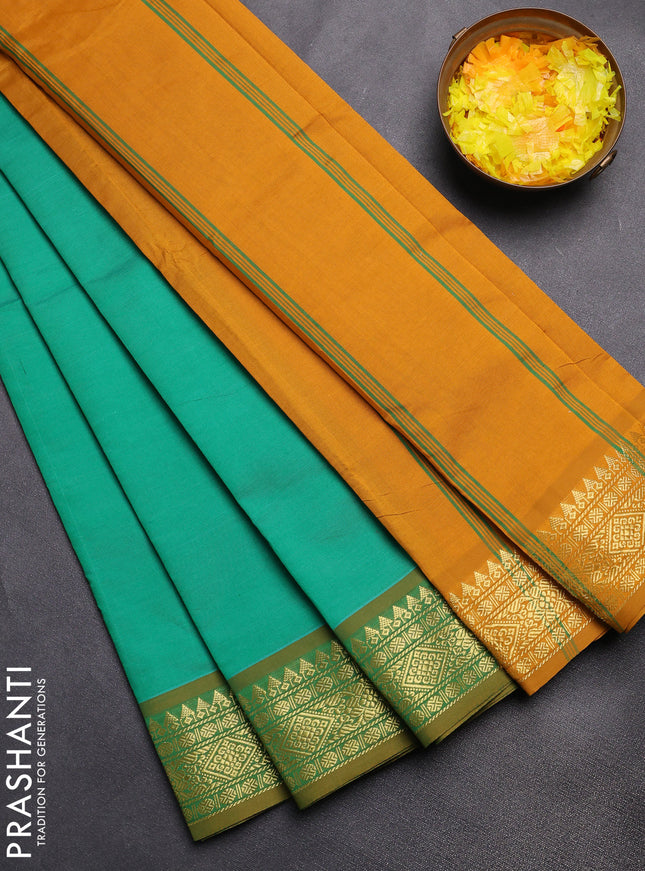 Semi silk cotton saree green and dark mustard with plain body and zari woven border