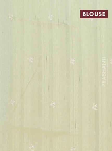 Semi raw silk saree pista green with embroidery buttas and floral embroidery border