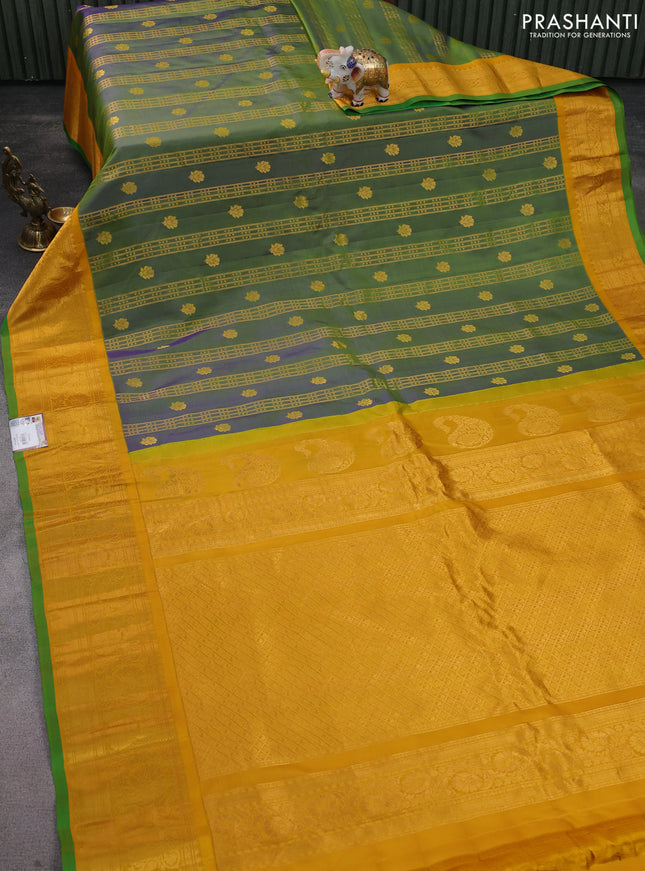 Pure gadwal silk saree dual shade of bluish green and yellow with allover zari weaves & buttas and zari woven border