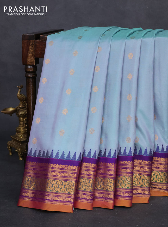 Pure gadwal silk saree dual shade of teal green and purple with zari woven buttas and temple design zari woven border