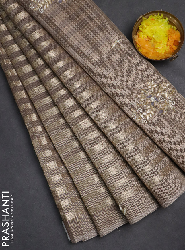 Kota tissue saree pastel brown with allover zari weaves and embroidery butta border