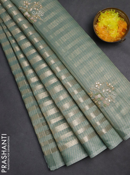 Kota tissue saree teal green with allover zari weaves and embroidery butta border