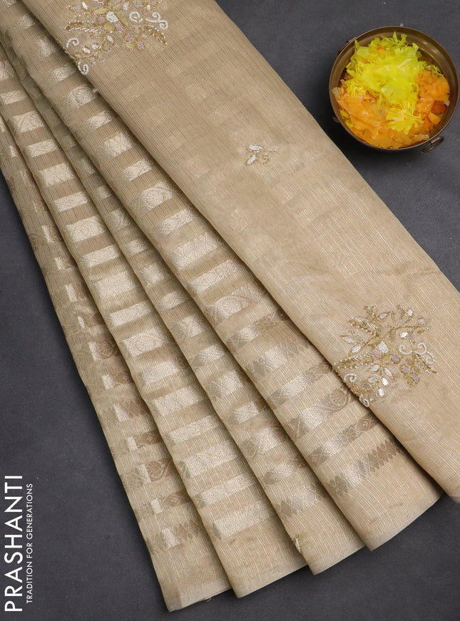 Kota tissue saree beige with allover zari weaves and embroidery butta border