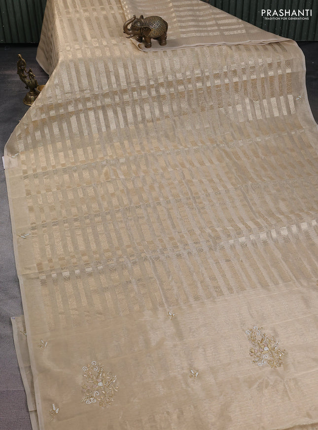 Kota tissue saree beige with allover zari weaves and embroidery butta border
