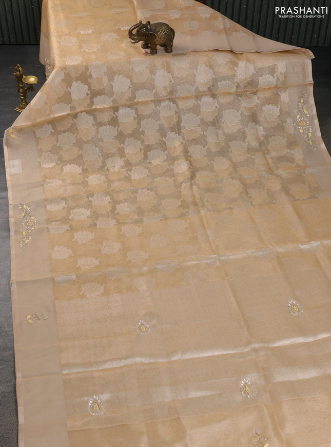 Kota tissue saree sandal with zari woven floral buttas and embroidery butta border