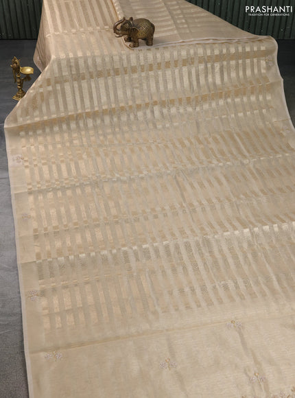 Kota tissue saree beige with allover zari weaves and embroidery butta border