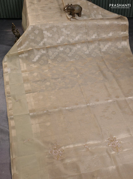 Kota tissue saree sandal with allover zari weaves and zari woven embroidery butta border