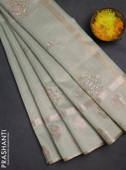 Kota tissue saree pastel green with embroidery buttas and zari woven floral butta border
