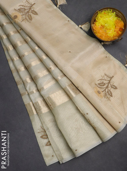 Kota tissue saree beige with allover zari weaves & embroidery buttas and zari woven embroidery butta border