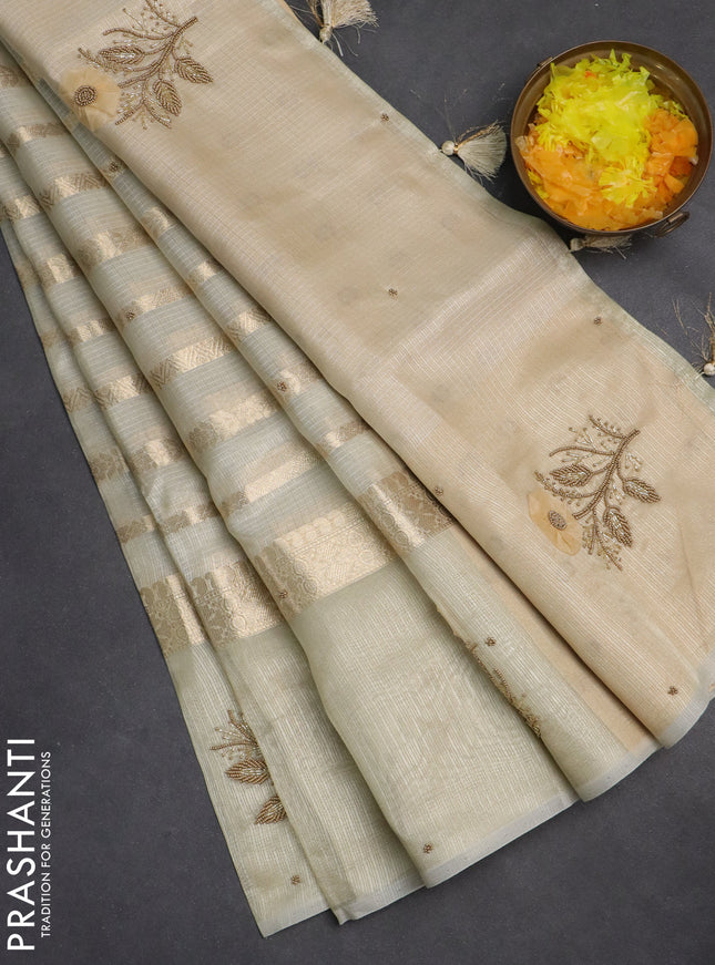 Kota tissue saree beige with allover zari weaves & embroidery buttas and zari woven embroidery butta border