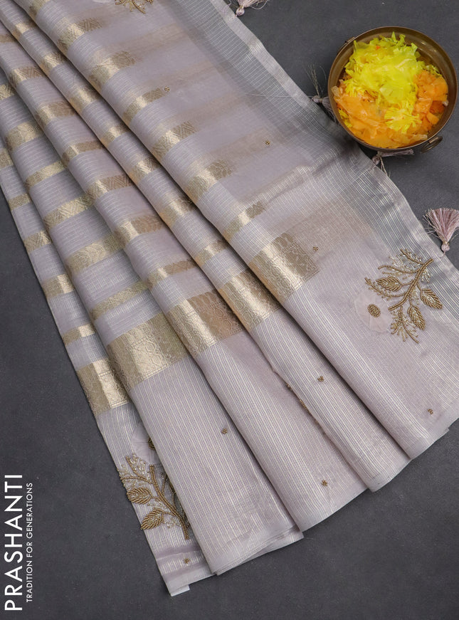 Kota tissue saree pastel lavender with allover zari weaves & embroidery buttas and zari woven embroidery butta border