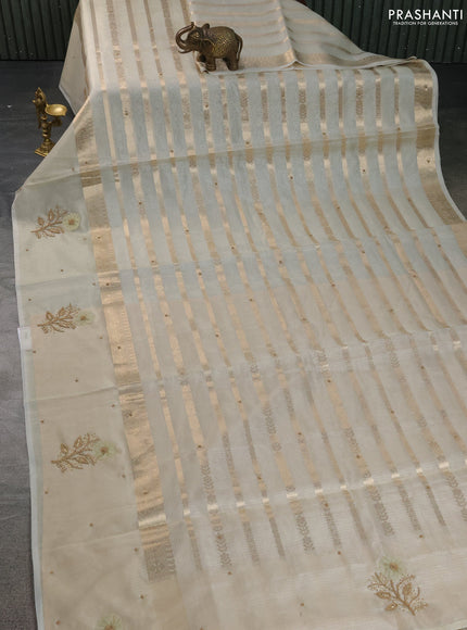 Kota tissue saree mild pista green and sandal with allover zari weaves & embroidery buttas and zari woven embroidery butta border