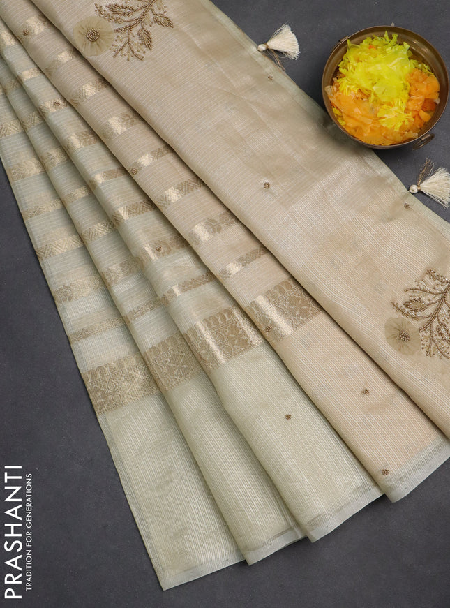 Kota tissue saree beige with allover zari weaves & embroidery buttas and zari woven embroidery butta border