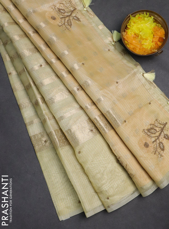 Kota tissue saree pale yellow with allover zari weaves & embroidery buttas and zari woven embroidery butta border