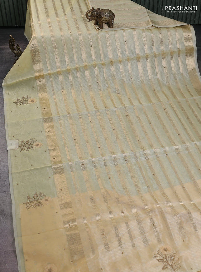 Kota tissue saree pale yellow with allover zari weaves & embroidery buttas and zari woven embroidery butta border