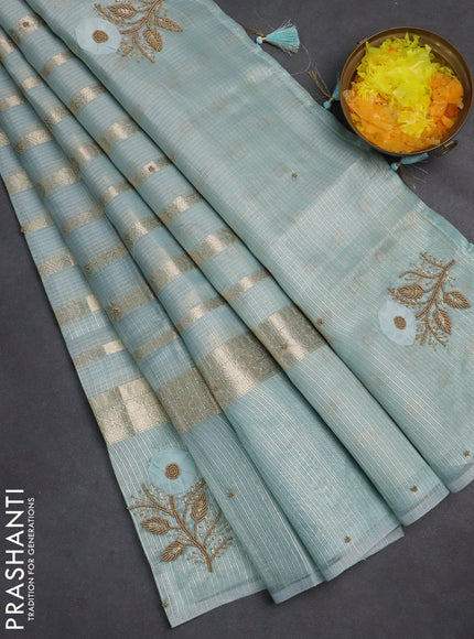 Kota tissue saree teal blue with allover zari weaves & embroidery buttas and zari woven embroidery butta border