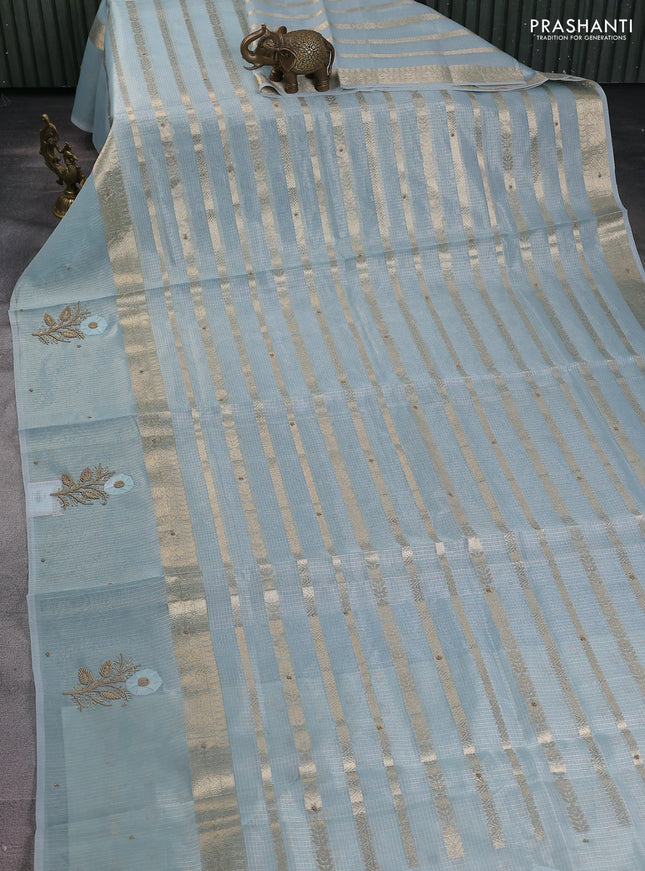 Kota tissue saree teal blue with allover zari weaves & embroidery buttas and zari woven embroidery butta border