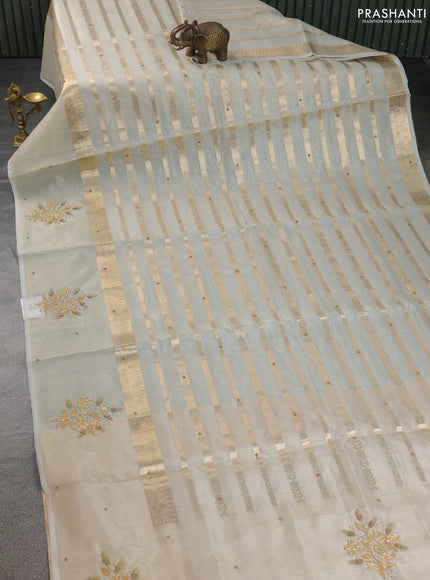 Kota tissue saree sandal with allover zari weaves & embroidery buttas and embroidery butta border