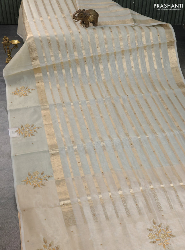 Kota tissue saree sandal with allover zari weaves & embroidery buttas and embroidery butta border