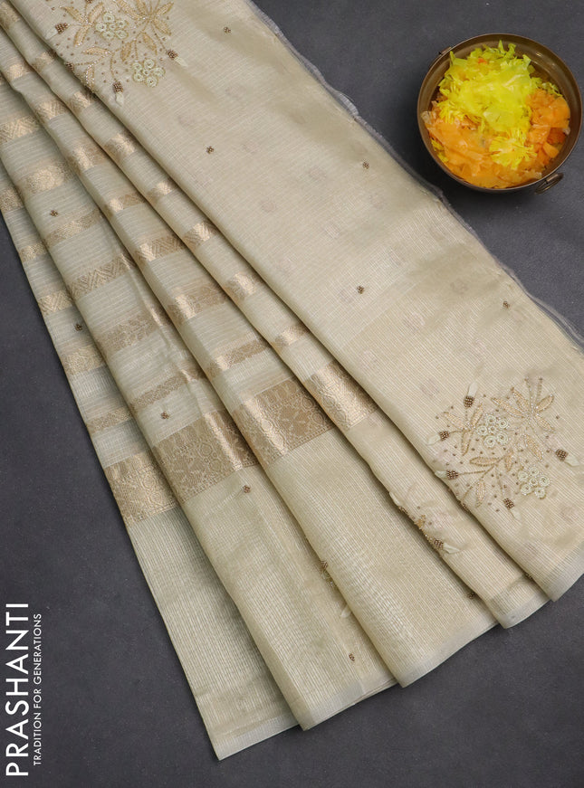 Kota tissue saree beige with allover zari weaves & embroidery buttas and embroidery butta border