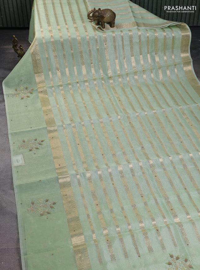 Kota tissue saree pista green with allover zari weaves & embroidery buttas and embroidery butta border