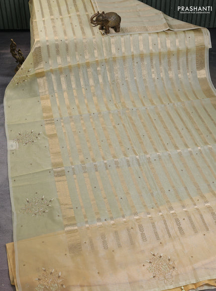 Kota tissue saree pista green with allover zari weaves & embroidery buttas and embroidery butta border