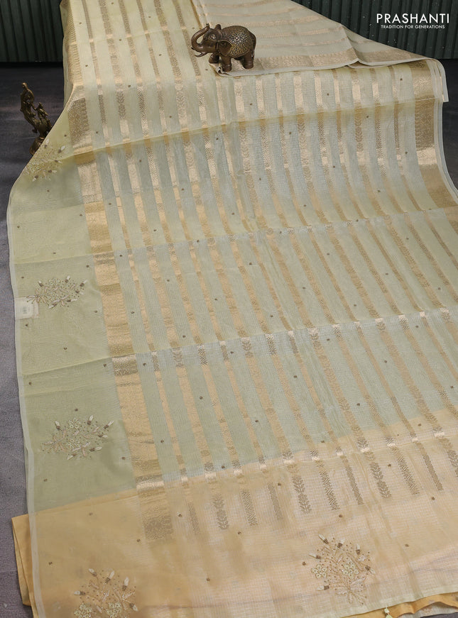 Kota tissue saree pista green with allover zari weaves & embroidery buttas and embroidery butta border