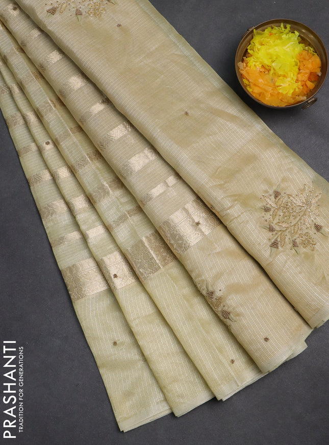 Kota tissue saree sandal with allover zari weaves & embroidery buttas and embroidery butta border