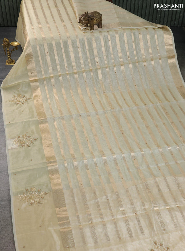 Kota tissue saree sandal with allover zari weaves & embroidery buttas and embroidery butta border