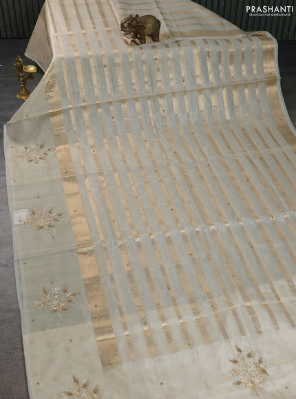 Kota tissue saree sandal with allover zari weaves & embroidery buttas and embroidery butta border