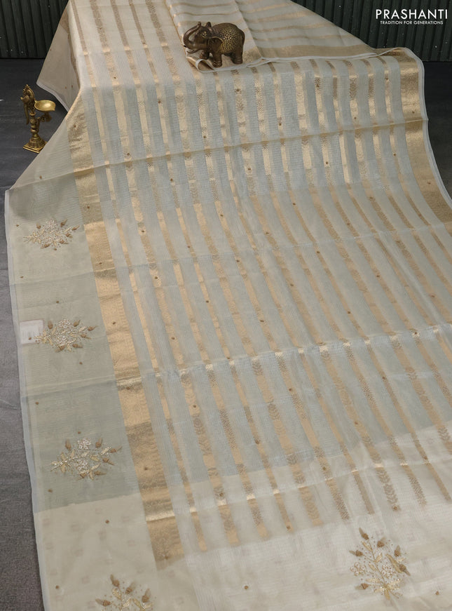 Kota tissue saree sandal with allover zari weaves & embroidery buttas and embroidery butta border