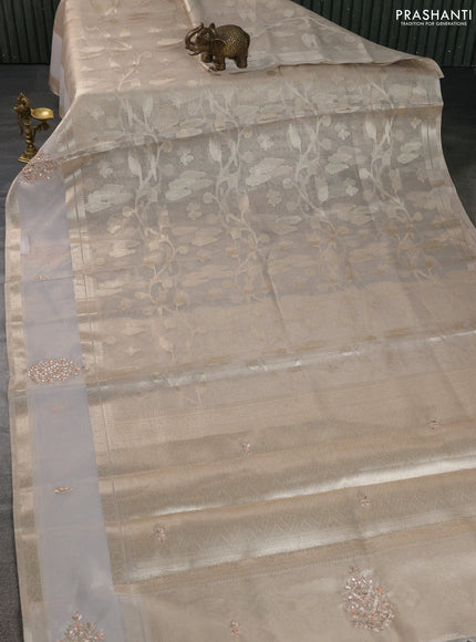 Kota tissue saree beige with zari woven buttas and embroidered butta boder