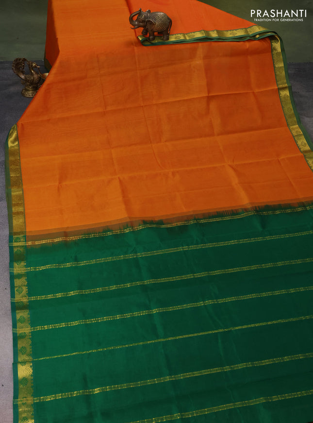Silk cotton saree orange and green with plain body and zari woven border