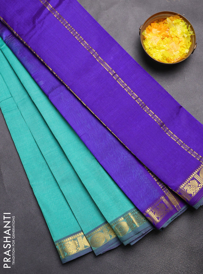 Silk cotton saree teal green and blue with plain body and zari woven border