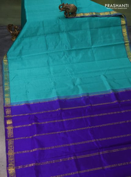 Silk cotton saree teal green and blue with plain body and zari woven border