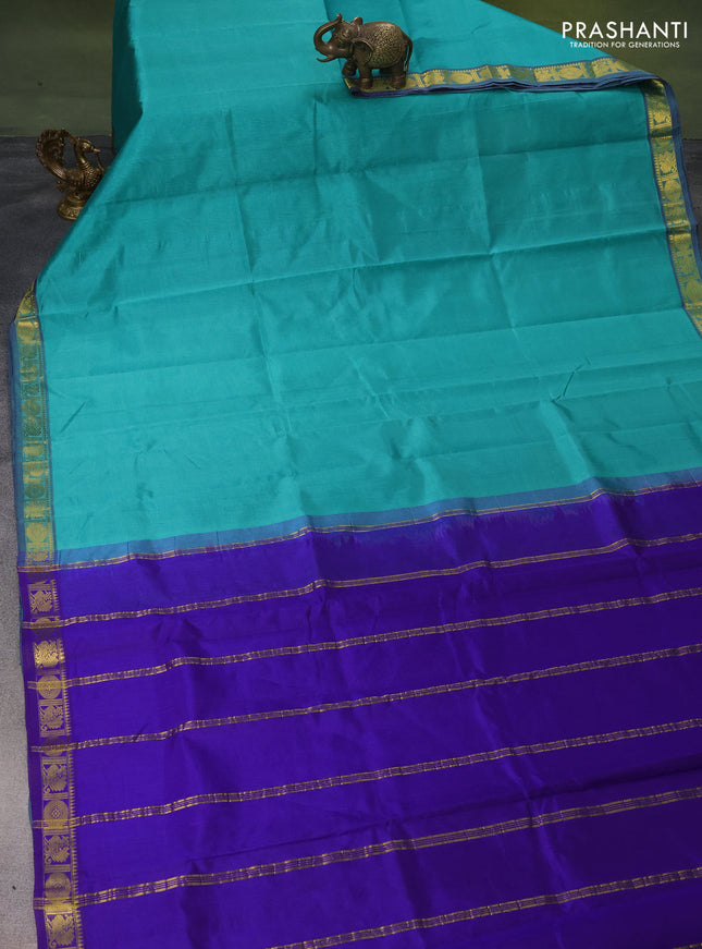 Silk cotton saree teal green and blue with plain body and zari woven border