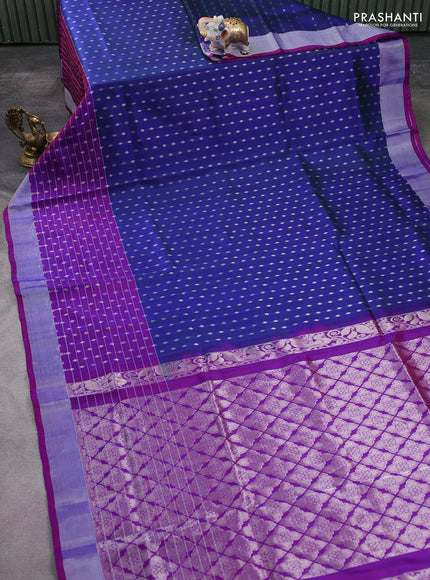 Pure uppada silk saree dual shade of bluish green and purple with allover silver zari woven butta weaves and silver zari woven border