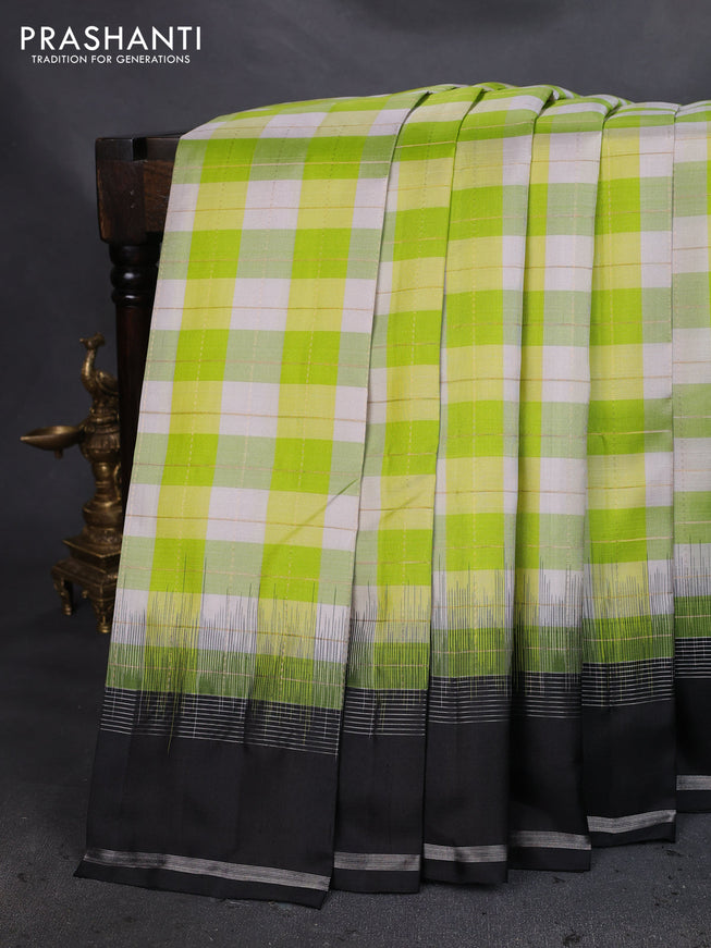Pure soft silk saree light green off white and black with allover zari checked pattern and rettapet zari woven border