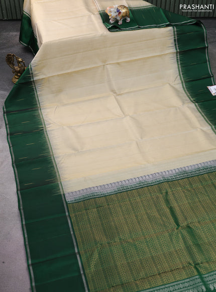 Pure soft silk saree cream and green with allover silver & gold zari woven butta weaves and long zari woven butta border