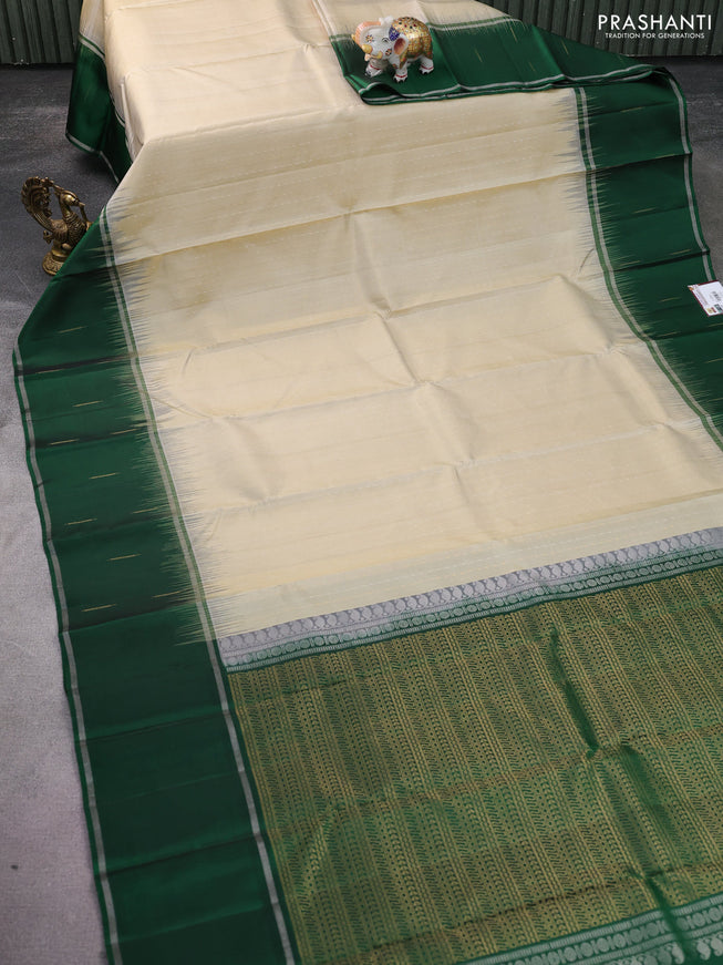 Pure soft silk saree cream and green with allover silver & gold zari woven butta weaves and long zari woven butta border