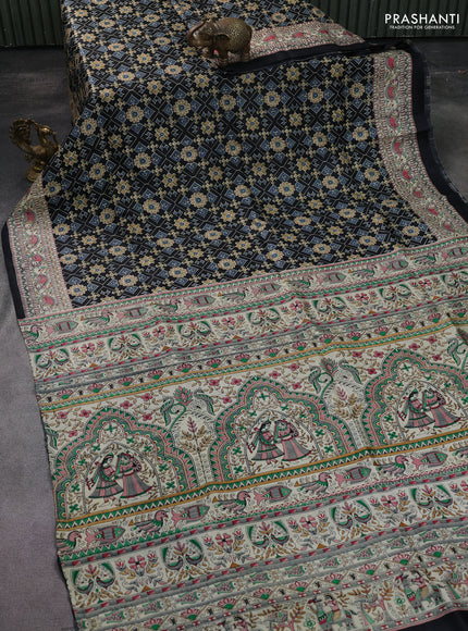 Printed silk saree black and cream with allover ikat prints and madhubani printed pallu & border