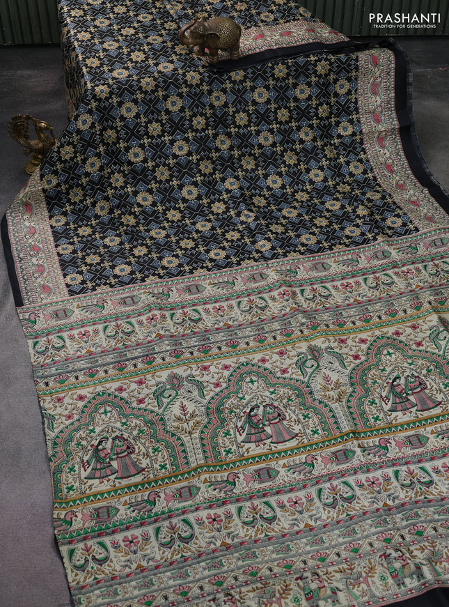 Printed silk saree black and cream with allover ikat prints and madhubani printed pallu & border