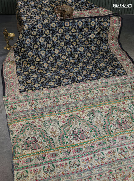 Printed silk saree black and cream with allover ikat prints and madhubani printed pallu & border